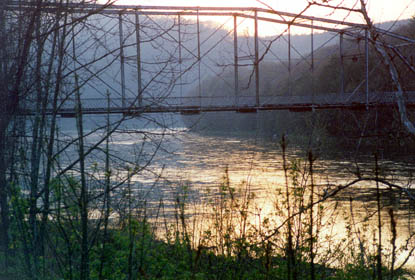 The sun reflects off of the water running beneath the Pond Eddy bridge in Pond Eddy, NY.